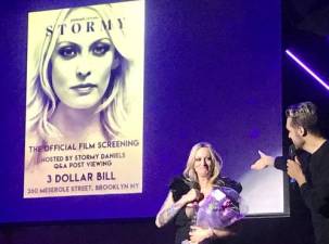 <b>Stormy Daniels, the adult film star whose real name is Stephanie Cliffords, is introduced by Andrew Barret Cox, at a viewing party at the Three Dollar Bill for a new documentary about her life entitled “Stormy.”</b> Photo: Marie Pohl