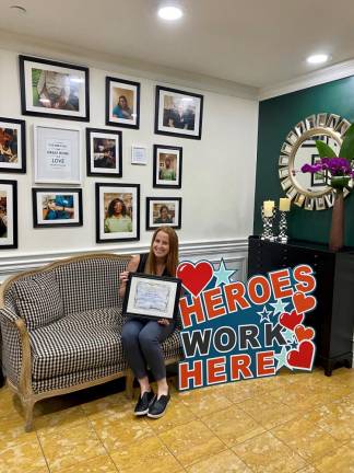 Activities Director Jackie Lebau of the 80th Street Residence with the 2020 All-Star Staff Award from the Empire State Association of Assisted Living. Photo courtesy of 80th Street Residence