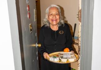 A West Side senior receives her home-delivered meal from ENCORE Community Services. Photo courtesy of ENCORE Community Services