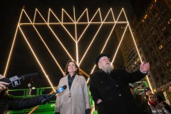 Governor Kathy Hochul participates in a menorah lighting on the first night of Hanukkah, alongside Rabbi Shmuel Butman of the Lubavitch Youth Organization. It took place at the world’s largest menorah, located at Central Park South’s Grand Army Plaza.