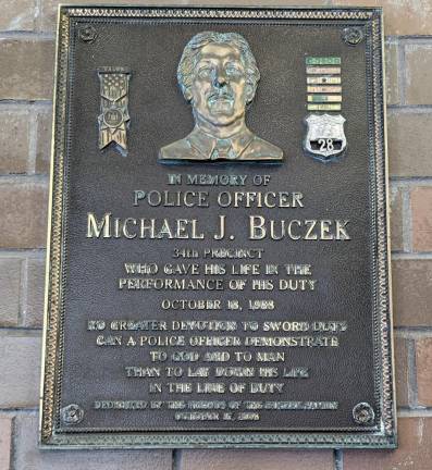 A plague honoring Officer Michael Buczek is on display outside the 34th Pct. where he was wokring the night he was killed on Oct. 18, 1988. Photo: Brian Berger