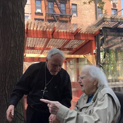 Malachy McCourt chats with East Village rebel priest, Father Pat Maloney, who runs Lazarus House on the Lower East Side and once spent nearly six years in prison after he was accused and convicted of running funds to the Irish Republican Army. Photo: Keith J. Kelly