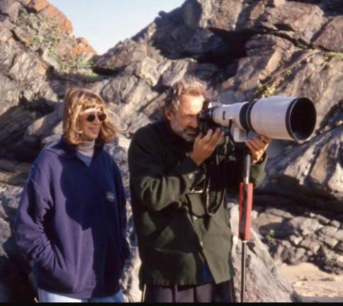 Director Creates Filmic Ode to Legendary Sports Illustrated Swimsuit Editor On a location, Jule Campbell during her SI career, stands next to photographer Walter Iooss as he takes the shot. Weather on the shoots was not always 85 and sunny, as the jackets attest to.