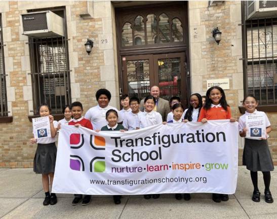 <b>Students from Transfiguration School in Chinatown gather with their principal Michael Lenahan after learning they won a prestigious National Blue Ribbon Award from the US Dept. of Educatio</b>n. Photo: Facebook