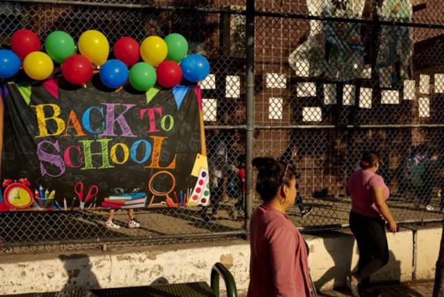 Parents walk past a Back to School welcome sign on the first day of class earlier this month. Photo: Gabby Jones for Chalkbeat