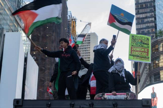 Protestors climbed atop a shipment box in the middle of Times Square.