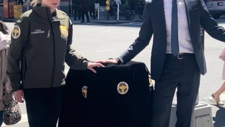 NYC Sanitation Commissioner Jessica Tisch (left) and City Council Member Erik Bottcher preparing to unveil a new–and hopefully rat-proof–trash can on the corner of 9th Ave. &amp; 43rd St., which is within Bottcher’s Hell’s Kitchen district.