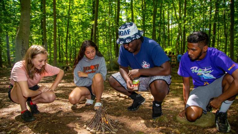There is a fine art to building a campfire as campers at the Nature Place Camp in Chestnut Ridge in Rockland County discover. This camp here will not find competitive sports, loudspeakers, or screens. Instead, campers get outside, explore, create, cooperate, play, and wonder. Photo: The Nature Place