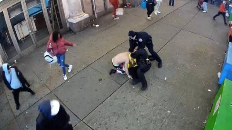 Venezuelan Migrant woman, Edgarlis Vegas (pictured on left side) wearing a burgundy jacket standing by in the Times Square assault on two cops at 220 West 42 Street, with another migrant suspect who previously got arrested and sent to Rikers Island.