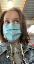 Author Leah Foreman snaps a selfie as she walks through the East Village donning a blue surgical face mask in February 2021.