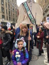 <b>Kimberly Schiller carries a shirtwaist banner with the name of one of the 146 people who died in the Triangle Shirtwaist Factory in 1911 in the biggest fire tragedy in the city’s history. Her daughter Anna Lee carries three white roses. </b> The victims were mostly poor Jewish and Italian immigrants. Photo: Keith J. Kelly