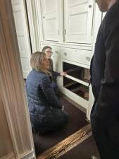 The bottom two drawers of the dresser are removed to expose the hidden passageway