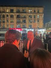 Manhattan District Attorney Alvin Bragg chats with a reporter at a watch party outside the Harlem Tavern on Election Night after being declared the projected winner in the race against two challengers.