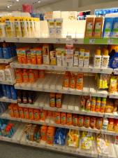 A drugstore featuring a shelf full of sunscreen