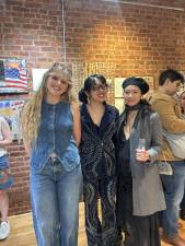 Camille (left) stands with fashion designer Kalita Hon (middle), and guest Ilona Ho (right) who came to see her show at the Neighbor Gallery in Chelsea on Feb. 11