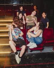 Queer Window members Loie Plautz, Sarah Franco, Marisa Winckowski, Aran Abilock Clemmons, Seyoung Kim, Zoe Johnson and Matt Grote laugh together at the Upright Citizens Brigade.