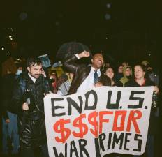 New York State Assemblymember Zohran Mamdani, Sen. Jabari Brisport, and Council Member Alexia Avilés march with a group of protesters, holding a banner that calls for the end of U.S. military aid to Israel.