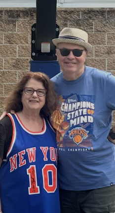 The writer, Gwen Westley Sullivan sports her Walt Frazier #10 jersey, personally autographed by Clyde, as she poses with husband Mark Sullivan. Thirty years ago, they shared season tickets to the New York Knicks.