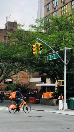 A deliverista runs a red light at the intersection of E. 29th St. and First Ave.