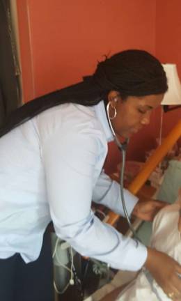 Visiting Nurse Service of New Yor hospice nurse Claudia Paul checks in on a patient. Photo courtesy VNSNY