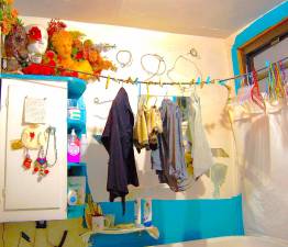 Clothes hang over the tub in an East Village apartment. The tenant has lived in the neighborhood since 1981.