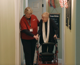 A SYNERGY caretaker helps a client walk. Photo courtesy of Mandy Cline