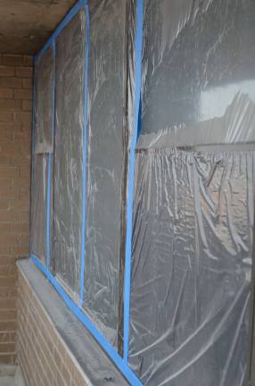Gabriel Wimberly's windows covered in&#xa0;plastic sheeting, as seen from the balcony.&#xa0;Photo: Daniel Fitzsimmons