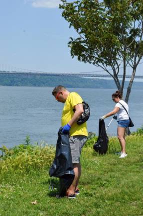 Trash Hero New York volunteers Ross Paterson (left) and Fleur Sohtz (right) collect litter by the Hudson River. Photo: Abigail Gruskin