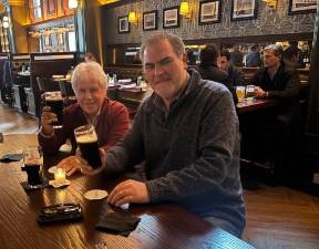 Des O’Brien (right) enjoys a pint of Guinness in the new Langan’s with fellow pub owner Frank Dwyer, who owns the nearby Playwright Tavern and Hurley’s.