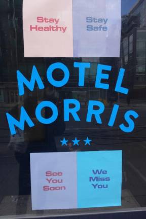 Signs in the window of the Motel Morris in Chelsea.