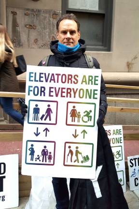 Demonstrator makes his point about subway elevators at a November fare hike protest at Baruch College. Photo: Meredith Kurz