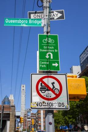 Manhattan entrance of Queensboro Bridge. Bike lane start with signs prohibiting mopeds in the lane.