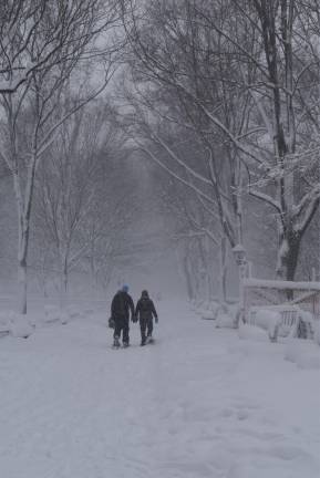 Two hearty travelers make their way across Riverside Park wearing snowshoes on the night of Feb. 22, as the blizzard hit the city full force.