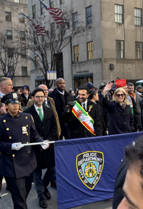 Mayor Zohran Mamdani (sash) heads up Fifth Ave. with NYPD Commissioner Jessica Tisch (waving at you!) and in red hat, Cardinal Timothy Dolan, the newly appointed co-chief chaplain of the NYPD.