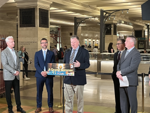 Bruce Caulfield, Principal Owner of Tracks Raw Bar and Grill at Grand Central Madison address media representatives at a press conference about the summer activities at Grand Central. Already 8 months behind schedule, the delayed opening of the first GCM retail space should be next month.