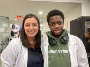 Emmanuel Olushki in his white coat with his DO student mentor Sofia Cedeno. Photo: Barbara Franklin