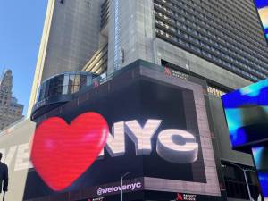 The new logo broadcast on a screen in Times Square. <b>Photo: Kay Bontempo.</b>