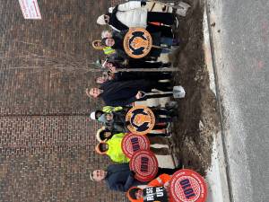 City Council Member Erik Bottcher (center) poses with a sapling, the 1,000th he’s planted locally during his time representing Chelsea and Hell’s Kitchen. He was joined by local laborers, allies, and Parks Department reps.