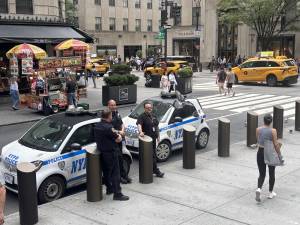 Police stand guard outside St. Patrick’s Cathedral, a day after a shooting at a Catholic church in Minneapolis killed two children and wounded 17 people. The NYPD said they were stepping up police presence at houses of worship across the city, but added they had not received any credible threats.