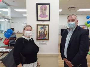 Meira Cohen stands next her paintings and art teacher Geoffrey Gneuhs at the Hamilton Annex Art Exhibit. Photo: Karen Camela Watson