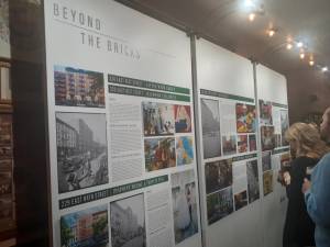 Guests view exhibit at Beyond the Bricks launch at Ryan’s Daughter on the Upper East Side. Photo: Karen Camela Watson