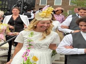 Jewelry designer to the stars Blair Husain shares a laugh as she is escorted into the Hat Show in the Conservancy Garden in Central Park.