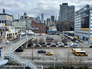 Across Twelfth Avenue from the <i>Intrepid</i> Museum, a parking lot for museum employees and buses will be transformed into a mixed-use commercial/residential tower that will include affordable housing.