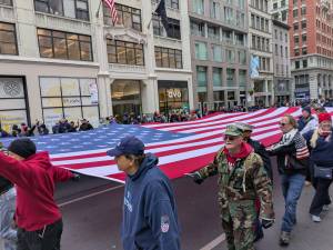 9/11 Volunteers carrying the American flag at Veterans Day Parade.