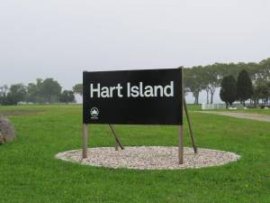 Upon reaching Hart Island, the usual NYC Parks Department green and white signage is a somber black and white, noting the resting place of many.