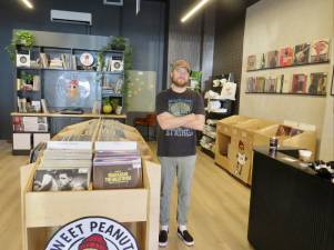 Proud owner Hunter Brammer stands in the middle of Sweet Peanut Nutters. John Lewis and Sascha Distel, the Fall and the Velvet Underground are among the jewels on the wall.