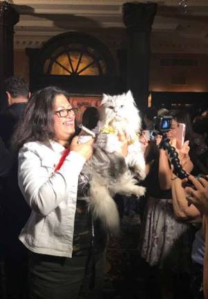 Ada Nieves, a cat fashion designer, with her cat, Martini. Photo: Charmaine P. Rice