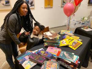 Kids and parents braved a driving rain to pick up free books donated by Upper West Side residents. Photo: Courtesy Gale Brewer’s City Council Office