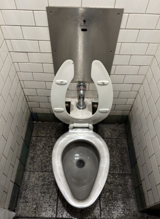 An example of a preexisting subway bathroom with an installed toilet seat.