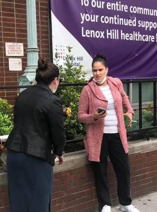 In front of a Lenox Hill Hospital banner.